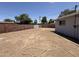 Large backyard area with dirt and long hose at 324 E Riviera Dr, Tempe, AZ 85282