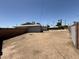 Spacious, empty backyard area awaiting landscaping, enclosed by block fencing at 324 E Riviera Dr, Tempe, AZ 85282