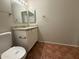 Bathroom featuring a toilet, granite vanity and mirror at 324 E Riviera Dr, Tempe, AZ 85282