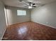 Empty bedroom with tiled floors, a ceiling fan and one window at 324 E Riviera Dr, Tempe, AZ 85282