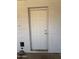 A standard white exterior door on the white brick wall at 324 E Riviera Dr, Tempe, AZ 85282