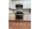 Updated kitchen featuring a stainless steel range and oven and white cabinets at 324 E Riviera Dr, Tempe, AZ 85282