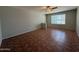 Inviting living room featuring tile floors, a ceiling fan and a front-facing window for natural light at 324 E Riviera Dr, Tempe, AZ 85282