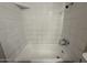 Bathroom featuring a bathtub with white tile surround and shower head at 324 E Riviera Dr, Tempe, AZ 85282