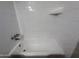 Bathroom shower featuring white tiled walls and shower head at 324 E Riviera Dr, Tempe, AZ 85282