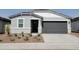 Charming single-story home featuring a gray exterior, landscaped front yard, and a two-car garage at 3498 N Camden Dr, Florence, AZ 85132