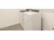 A modern laundry room features a white washer and dryer on gray tile flooring at 3498 N Camden Dr, Florence, AZ 85132