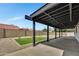 A covered patio overlooks a well-maintained backyard with gravel, grass, and trees under a blue sky at 3926 E Coconino St, Phoenix, AZ 85044
