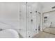 Elegant bathroom featuring a walk-in shower with marble tile and a soaking tub at 3926 E Coconino St, Phoenix, AZ 85044