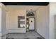 Inviting front entrance with a white door, modern light fixture, and neutral paint at 3926 E Coconino St, Phoenix, AZ 85044
