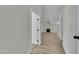 A bright hallway provides entry into a large living area with a wood-look flooring and modern fireplace at 3926 E Coconino St, Phoenix, AZ 85044