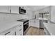 Bright kitchen features stainless steel appliances, white cabinets and quartz countertops at 3926 E Coconino St, Phoenix, AZ 85044