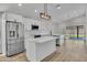 Modern kitchen featuring white cabinetry, stainless steel appliances, and an island with a quartz countertop at 3926 E Coconino St, Phoenix, AZ 85044