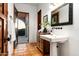 Classic bathroom with a pedestal sink, decorative mirror, and outdoor access at 40039 N 107Th Pl, Scottsdale, AZ 85262