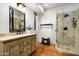 Bathroom featuring a vanity with decorative mirror, and a glass-enclosed shower with tile surround at 40039 N 107Th Pl, Scottsdale, AZ 85262
