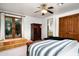 Inviting bedroom with tile entry to outdoor space and a separate bathroom entrance via wooden door at 40039 N 107Th Pl, Scottsdale, AZ 85262
