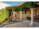 Charming courtyard with brick-paved walkway, lush landscaping, and architectural columns at 40039 N 107Th Pl, Scottsdale, AZ 85262