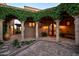 Inviting courtyard featuring stone pillars, vine-covered pergolas, and decorative ironwork on the main entryway at 40039 N 107Th Pl, Scottsdale, AZ 85262