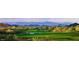 Beautiful golf course view with manicured green fairways and a backdrop of stunning mountain views at 40039 N 107Th Pl, Scottsdale, AZ 85262
