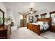 Spacious main bedroom with neutral carpet, wooden furnishings, and natural light through windows and doors at 40039 N 107Th Pl, Scottsdale, AZ 85262