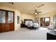 Spacious main bedroom featuring neutral colors, carpet, and access to a private balcony with mountain views at 40039 N 107Th Pl, Scottsdale, AZ 85262
