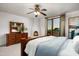 Bright main bedroom featuring a fireplace, fan, and sliding door access to outdoor views at 40039 N 107Th Pl, Scottsdale, AZ 85262