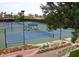 View of multiple tennis courts, landscaped surroundings, and seating for spectators at 40039 N 107Th Pl, Scottsdale, AZ 85262