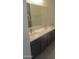 Bathroom showcasing a double sink vanity with modern fixtures and grey cabinets at 46129 W Barbara Ln, Maricopa, AZ 85139