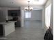 Open-concept kitchen features modern appliances, grey cabinets, and plenty of counter space at 46129 W Barbara Ln, Maricopa, AZ 85139