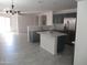 Bright kitchen with modern grey cabinets, stainless steel appliances, and a center island at 46129 W Barbara Ln, Maricopa, AZ 85139