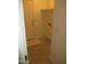 Neutral colored laundry room with tile flooring and a door to the outside at 46129 W Barbara Ln, Maricopa, AZ 85139