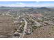 Expansive aerial view showcasing a well-planned community nestled among rolling hills and scenic mountain views at 6106 W Spur Dr, Phoenix, AZ 85083