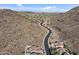 Breathtaking aerial view of a desert community nestled between mountains, showcasing the unique landscape and neighborhood design at 6106 W Spur Dr, Phoenix, AZ 85083