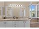 Bright bathroom featuring double sinks, granite counters and white cabinets, along with a shower and tub at 6106 W Spur Dr, Phoenix, AZ 85083