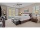 Bright bedroom with king bed, modern furnishings, carpet floors, and backyard pool access at 6106 W Spur Dr, Phoenix, AZ 85083