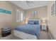This bedroom features a queen bed, ensuite bath, ceiling fan and a large window at 6106 W Spur Dr, Phoenix, AZ 85083