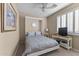 This bedroom features a murphy bed, neutral walls, ceiling fan, and a shuttered window at 6106 W Spur Dr, Phoenix, AZ 85083