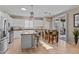 Kitchen featuring an island with bar seating, stainless steel appliances, and tile floors at 6106 W Spur Dr, Phoenix, AZ 85083