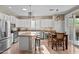 Bright kitchen with stainless steel appliances, central island, white cabinetry, and tile flooring at 6106 W Spur Dr, Phoenix, AZ 85083