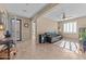 Open living room features tile floors, ceiling fan, and view to entryway and kitchen at 6106 W Spur Dr, Phoenix, AZ 85083