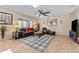 Spacious living room features neutral walls, ceiling fan, plush seating, and a decorative rug at 6106 W Spur Dr, Phoenix, AZ 85083
