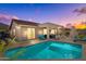 Inviting backyard pool with covered patio, outdoor seating, and mountain views provides a serene retreat at 6106 W Spur Dr, Phoenix, AZ 85083