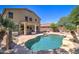 Expansive backyard with a pool, spa, covered patio, desert plants, and outdoor lounge seating at 708 E Dry Creek Rd, San Tan Valley, AZ 85143