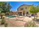 Lush backyard with pool, desert plants, hammock, spa, patio, and outdoor lounge seating at 708 E Dry Creek Rd, San Tan Valley, AZ 85143