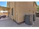 Backyard view of outdoor living space, patio, and backyard equipment for two-story tan home at 708 E Dry Creek Rd, San Tan Valley, AZ 85143