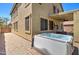 Backyard view features a hot tub and outdoor patio of this tan two-story home at 708 E Dry Creek Rd, San Tan Valley, AZ 85143