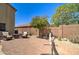 Desert landscaped backyard featuring lounge seating, desert plants, and rock ground cover at 708 E Dry Creek Rd, San Tan Valley, AZ 85143