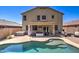 Well-maintained backyard with a pool, spa, patio area, desert plants, and outdoor lounge seating at 708 E Dry Creek Rd, San Tan Valley, AZ 85143