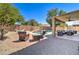 Desert landscaped backyard featuring lounge seating, pool, spa, outdoor lounge and desert plants at 708 E Dry Creek Rd, San Tan Valley, AZ 85143