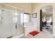 This bathroom features a soaking tub, walk-in shower, and an open doorway to the bedroom at 708 E Dry Creek Rd, San Tan Valley, AZ 85143